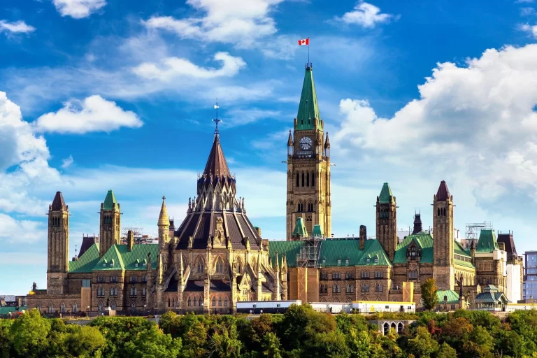 The Canadian Parliament in Ottawa, Canada, with the national flag flying.