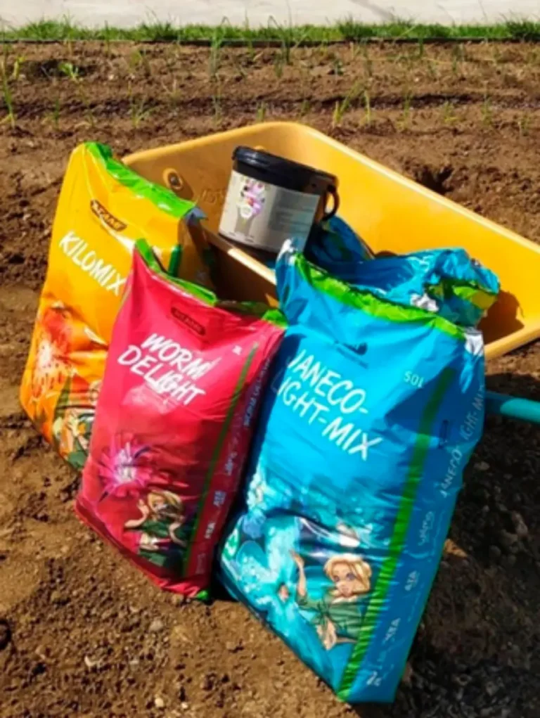 Atami substrates and ATA NRG Upgrade products displayed on a sandy field, promoting eco-friendly plant cultivation.